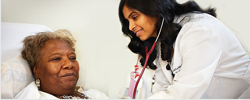 doctor with elderly patient in hospital