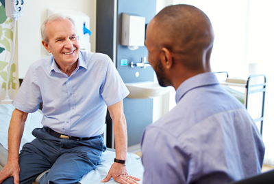 A younger man talking with an older man