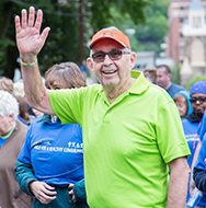 A walker waves to the camera