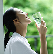 Woman holding a glass of water