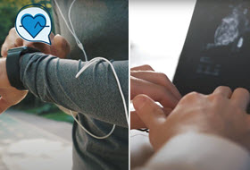 Closeup of wrist with a fitness device and hands at a laptop