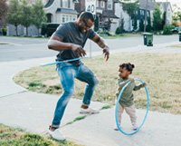 Father and daughter hulahooping