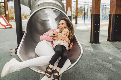 Mother and Daughter down a slide