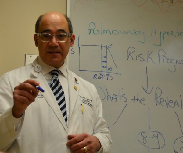 Dr. Benza standing in front of a whiteboard that has notes on pulmonary hypertension