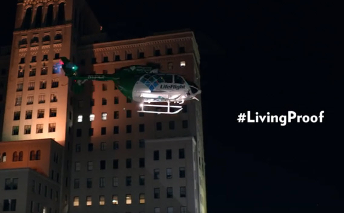 Screencap from a Living Proof video showing the LifeFlight helicopter lifting off in front of Allegheny General Hospital