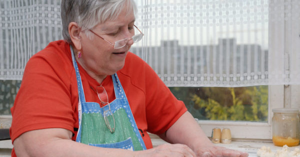 A senior woman baking in a kitchen