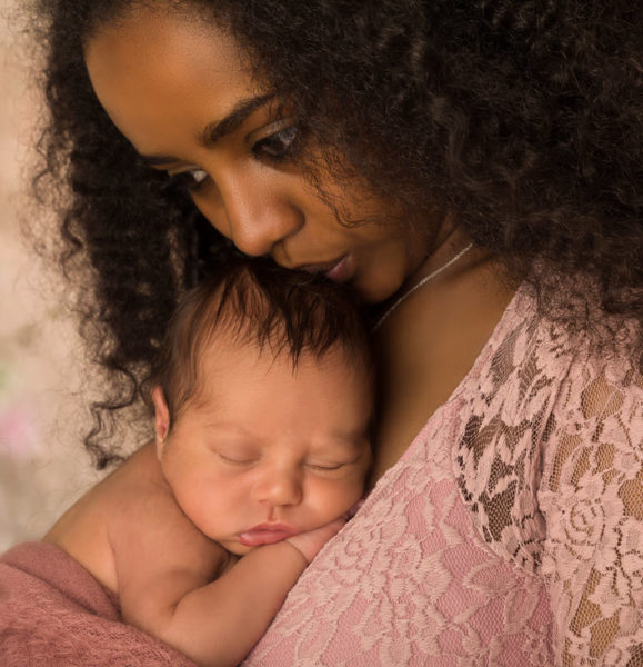 A young African-American woman holding a newborn