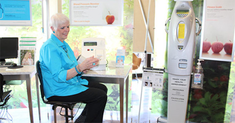 Stephanie Paul checks the readout after using her Highmark Direct store’s health assessment station.