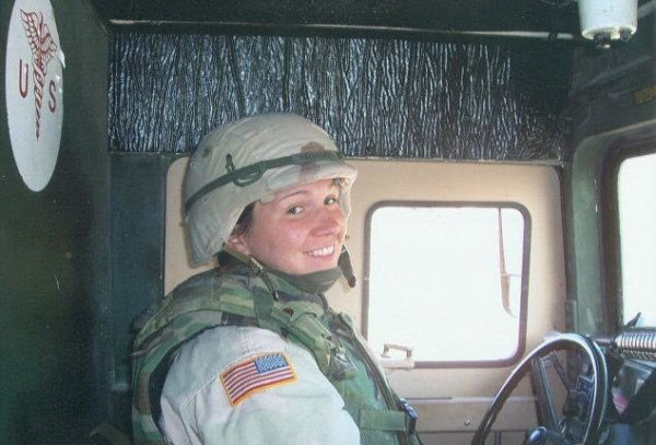 Jenny Pacanowski in the driver’s seat of a medical supply vehicle in Iraq