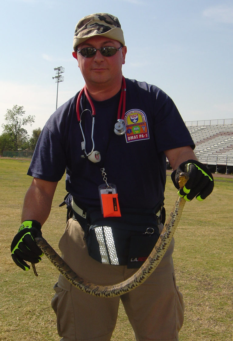 Jim Stupar holding a snake in New Orleans