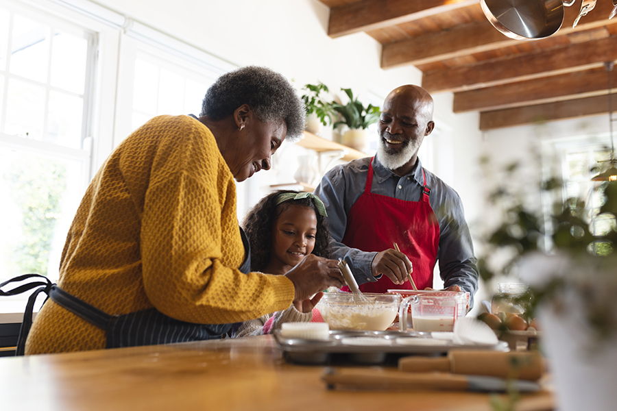 man and woman baking with grandchild