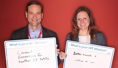 Me with my “Millennials on a Mission” reception co-chair Jon Mertz, holding our “Future of Health IT” signs